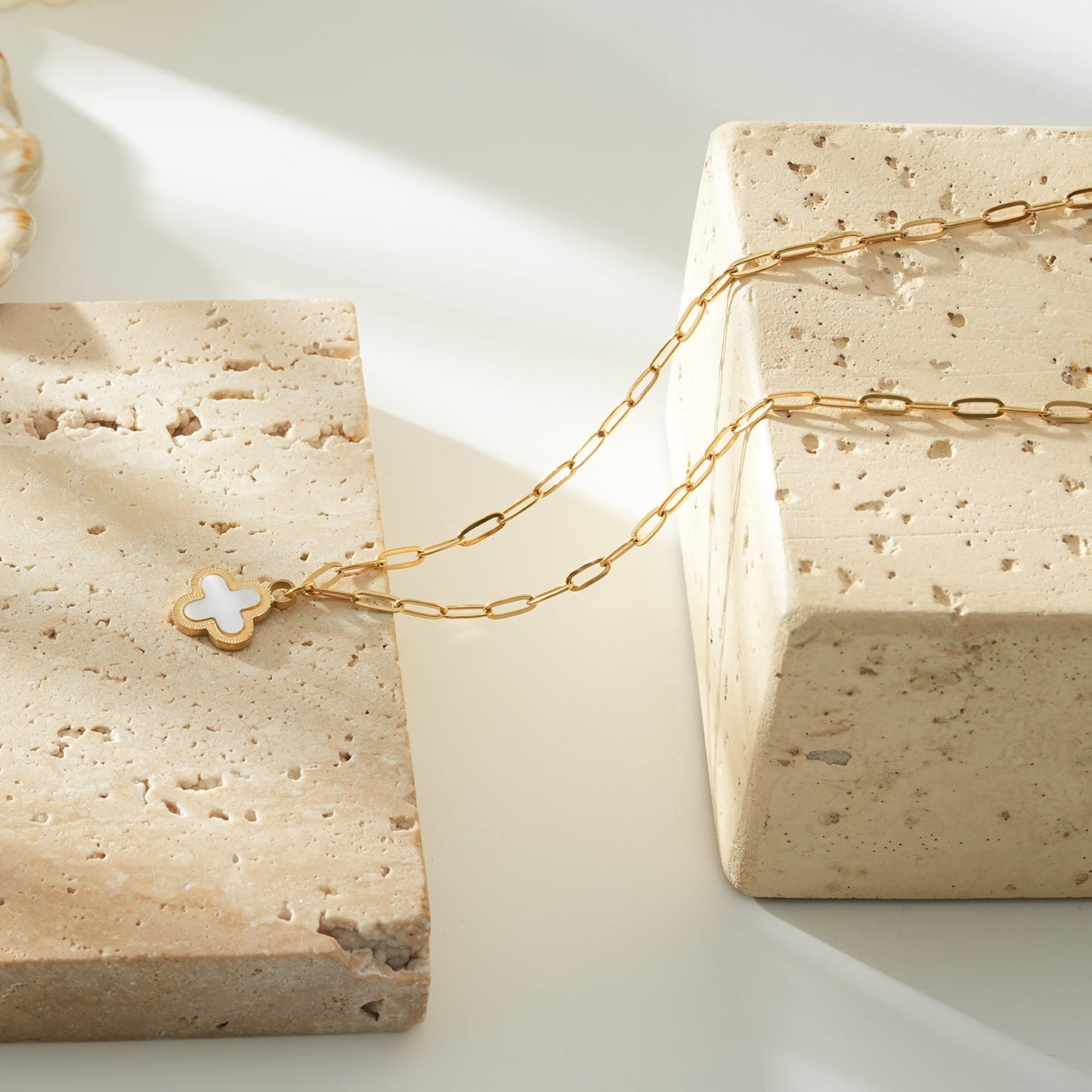MAKA Gold: Clover Shaped Charm in Natural Shell & Gold Metal Border on a Paperclip Chain