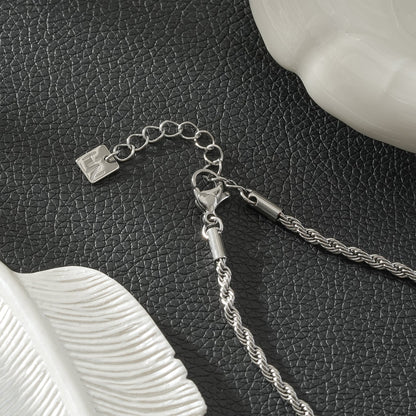 COSMINA Mixed Metals: Silver Rope Chain Necklace with Triple Mini Gold Criss-Cross Charms