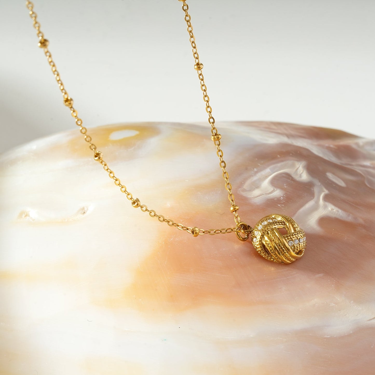 SALAMASINA Gold: Crystal Interwoven Knot Pendant Necklace