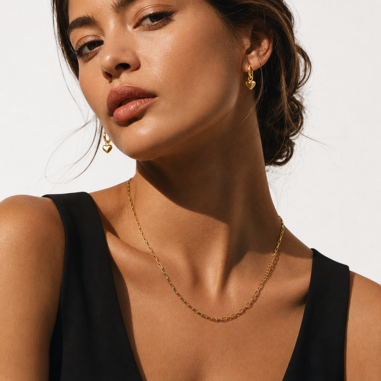 STOWE Gold: Mini Hoop Earrings Anchoring a Heart Shaped Charm